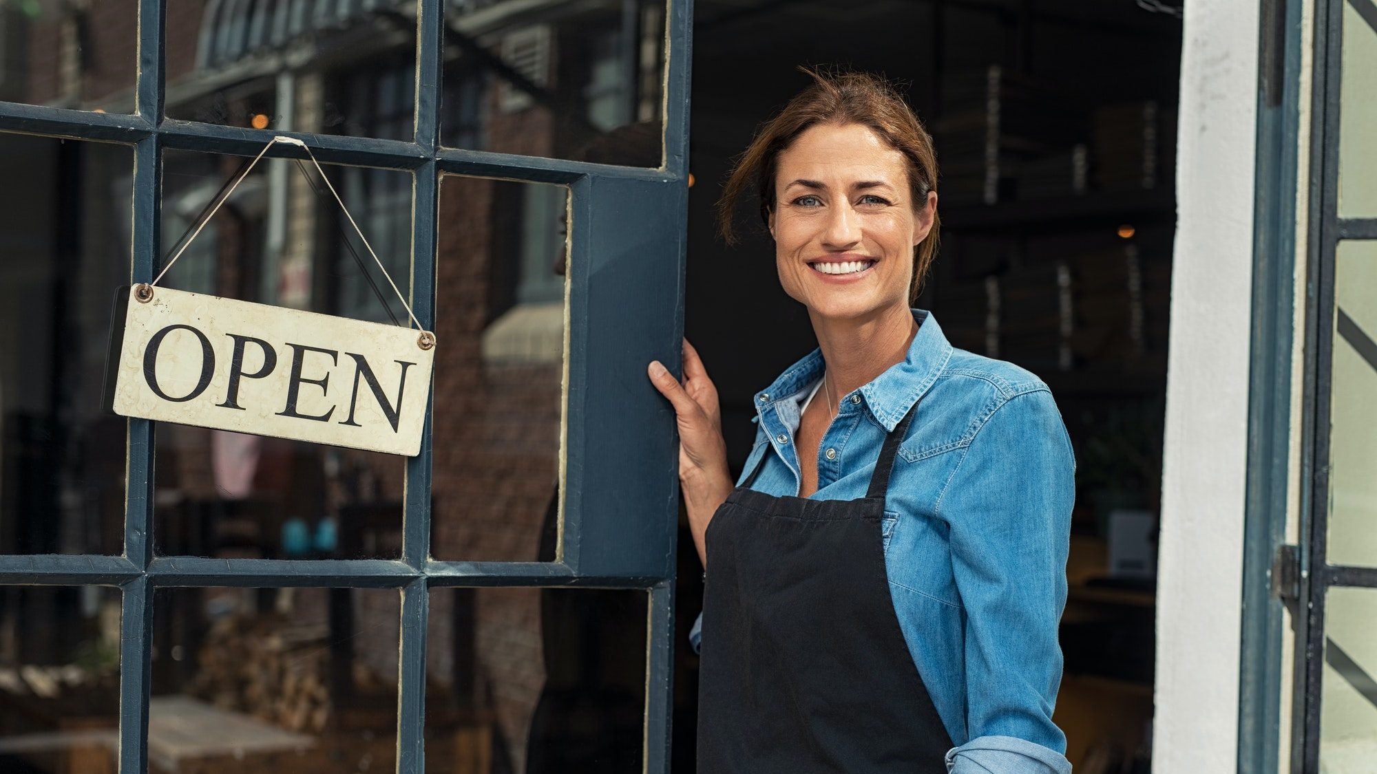 Woman at small business entrance